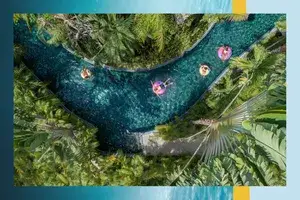 Aerial view of a family floating in tubes on a lazy river 