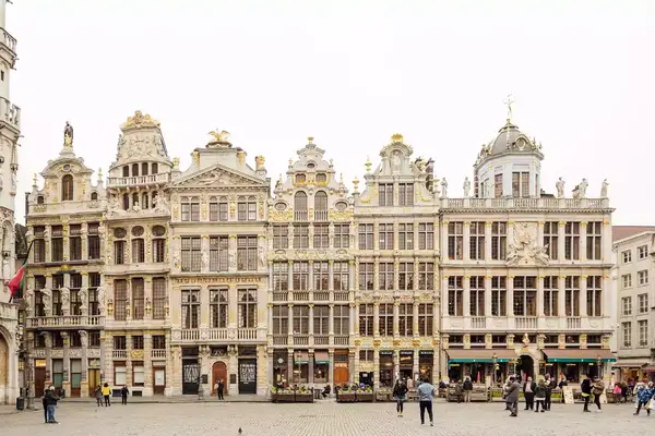 Grand Place square with historic buildings in Brussels, Belgium, people walking in the foreground