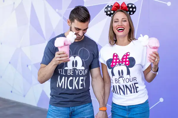 Newlywed couple enjoying desserts in Disney t-shirts
