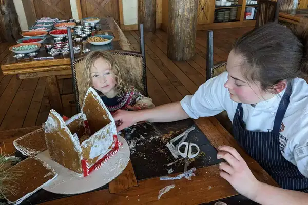 A little girl being entertained by one of the many kid-friendly activities at Brush Creek Ranch December