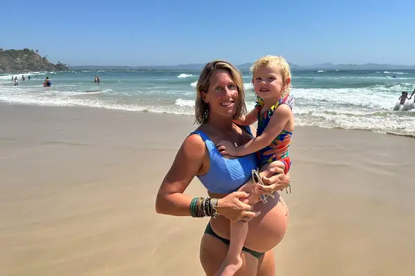 Kathryn Romeyn and her first born on the beach in Sydney 
