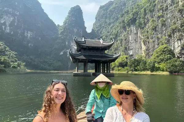 Mother and daughter on a boat with a boat steward in Ninh Binh 