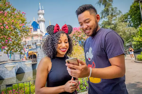 Guests using Genie+ app at Disneyland