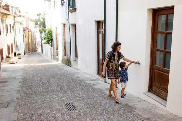 Mother and toddler playing at Arcos de Valdevez historic center in Portugal