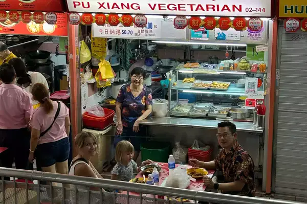 People eating at the Chinatown Complex Market & Food Centre in Singapore 