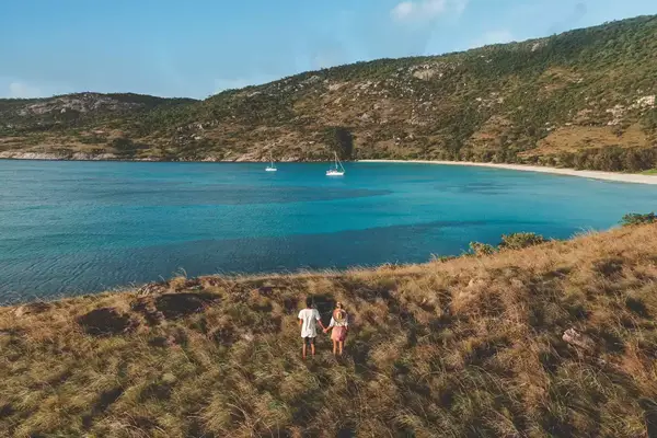 A couple standing on the coast of a Great Barrier Reef Island
