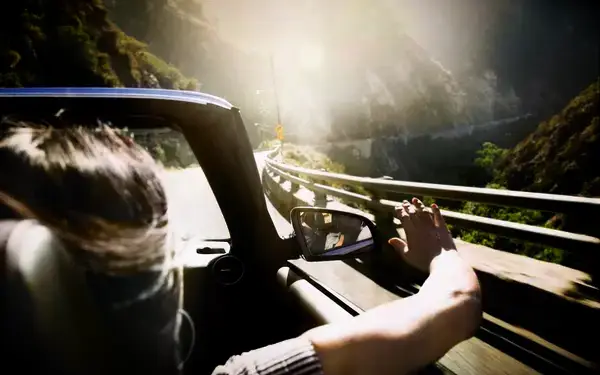 Woman in the passenger seat of a convertible