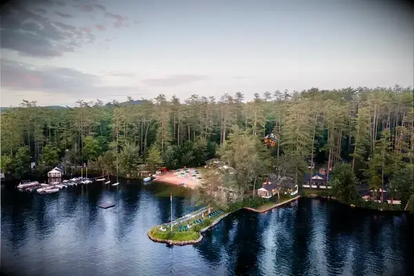 A scenic aerial view of a lakeside resort surrounded by trees and water