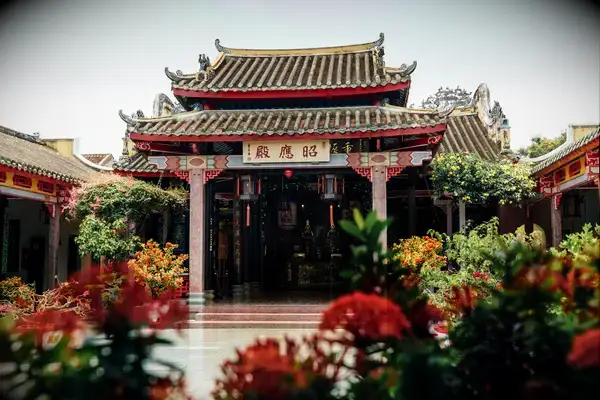 Ornate traditional Asian temple with a courtyard and vibrant floral decorations
