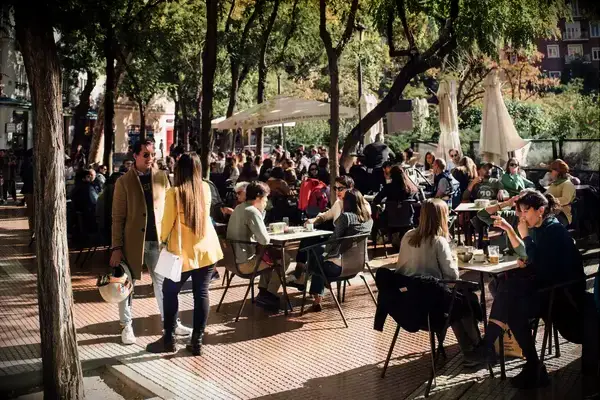 Diners at outside cafe tables in Madrid, Spain