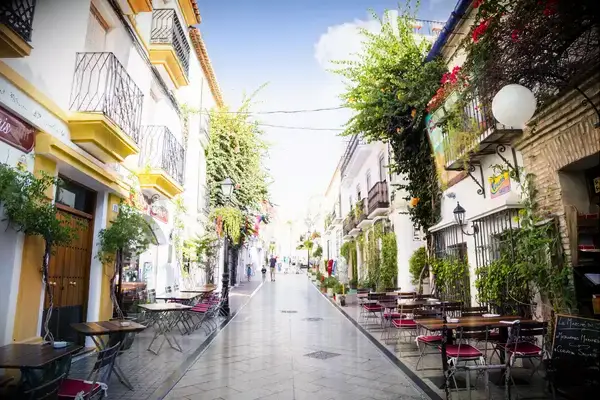 A table-lined steet in Marbella, Spain