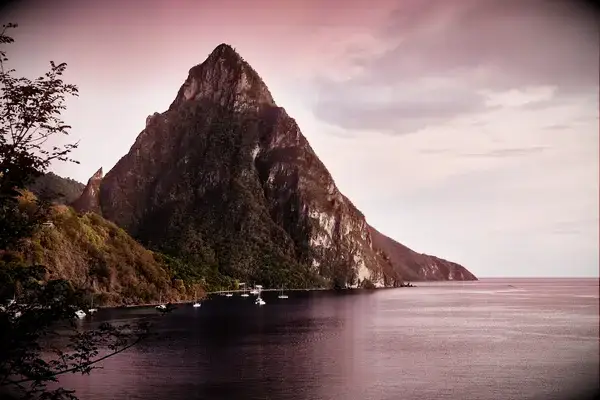 Petit Piton mountain in St. Lucia with a view of the ocean and anchored boats
