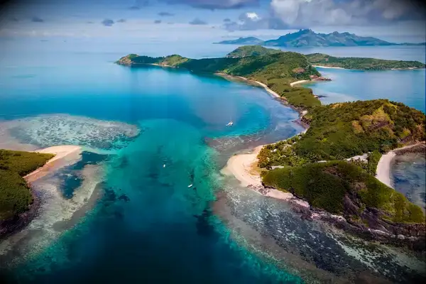 Aerial view of tropical islands and clear blue waters in a coastal region