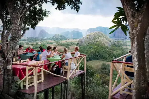 People eating at a restaurant overlooking a valley in Cuba