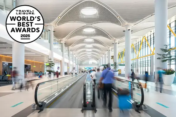 A modern airport interior featuring a moving sidewalk and travelers with 
