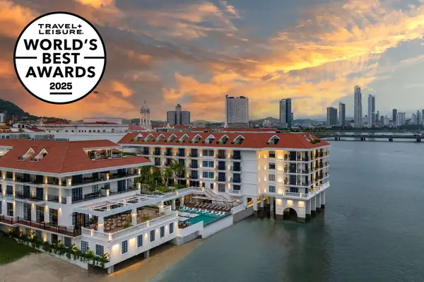 Hotel with waterfront view showcasing award recognition logo