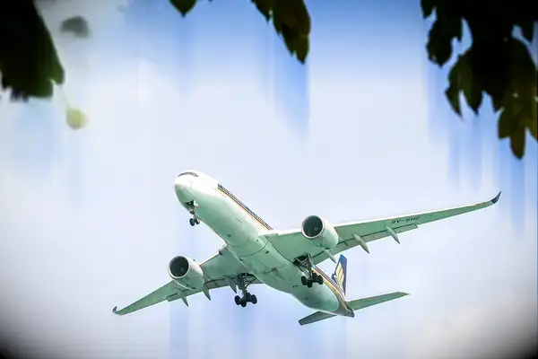 An airplane flying against a blue sky with a 