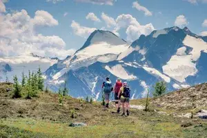 People hiking on a trail in a mountain region
