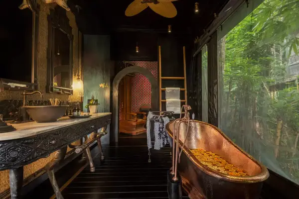 Bathroom with a copper tub and treetop views at the Capella Ubud Bali hotel