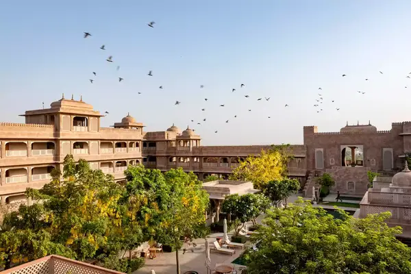 Birds fly over the Six Senses Fort Barwara hotel in India
