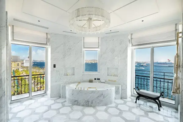 White marble guest room with river views at the Peninsula Istanbul hotel