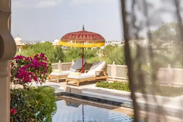 View of a private pool through lace curtains at the Oberoi Udaivilas resort