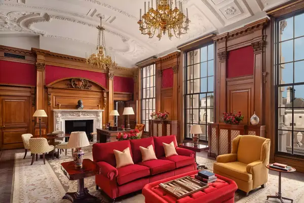 Red and gold lounge room at the Raffles London at the OWO hotel