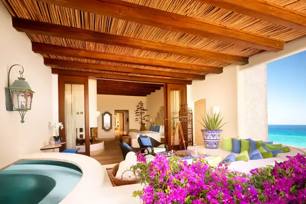 Villa terrace with pink flowers and a soaking tub at the Ventanas al Paraiso resort