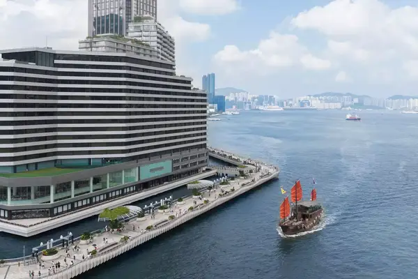 A boat sails past the Regent Hong Kong hotel