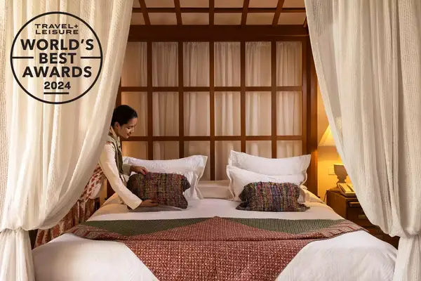 A staffer makes a bed at the Oberoi Rajvilas resort