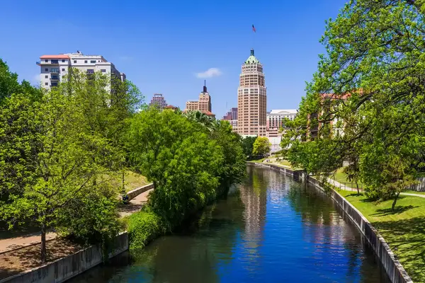 Riverwalk San Antonio Texas skyline, park walkway along scenic canal