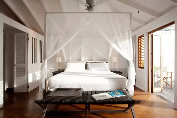 Airy white guest room at Le Sereno Resort in St Barth
