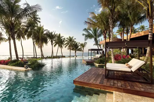 Pool lined by palm trees at the Dorado Beach, Ritz-Carlton Reserve in Puerto Rico
