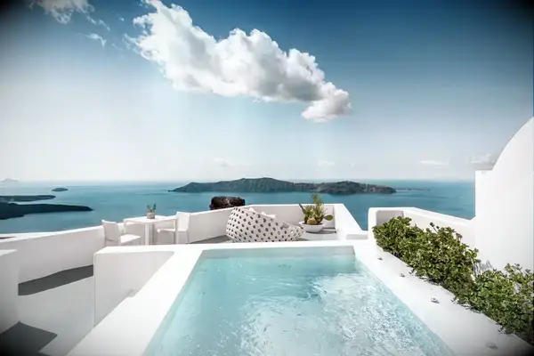 Seaside resort terrace with a pool, lounge area, and sea view