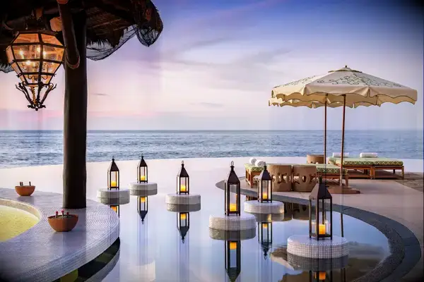 Sunset at the pool with candlelight at Waldorf Astoria Los Cabos Pedregal