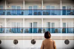 Woman looking up at a cruise ship