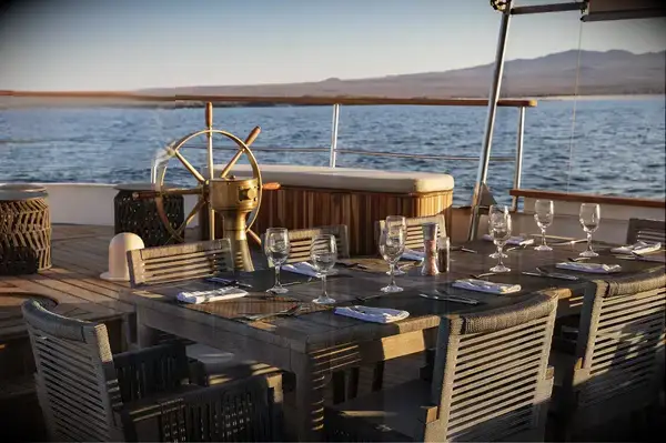Outdoor table setup on a yacht deck with Travel & Lanetrek World