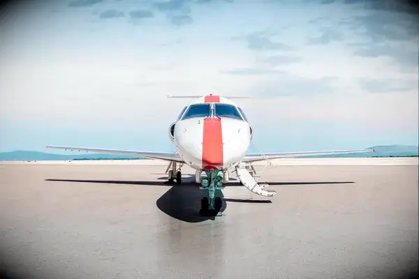 A small aircraft on a tarmac with its stairs extended
