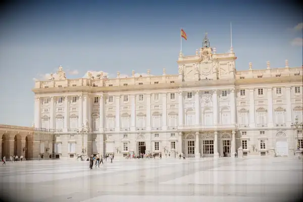 Courtyard of a grand architectural building with a flag on top