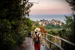 Female tourist walking towards Corniglia village, Beautiful town in Cinque Terre coast