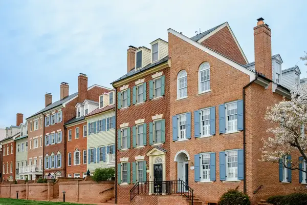 Row of townhouses with brick facades and shutters